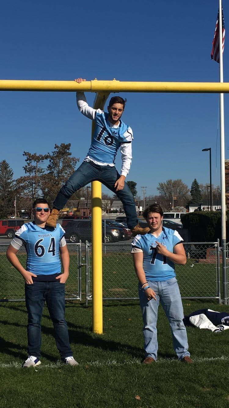 Dracut Middies football players posing at the goalpost